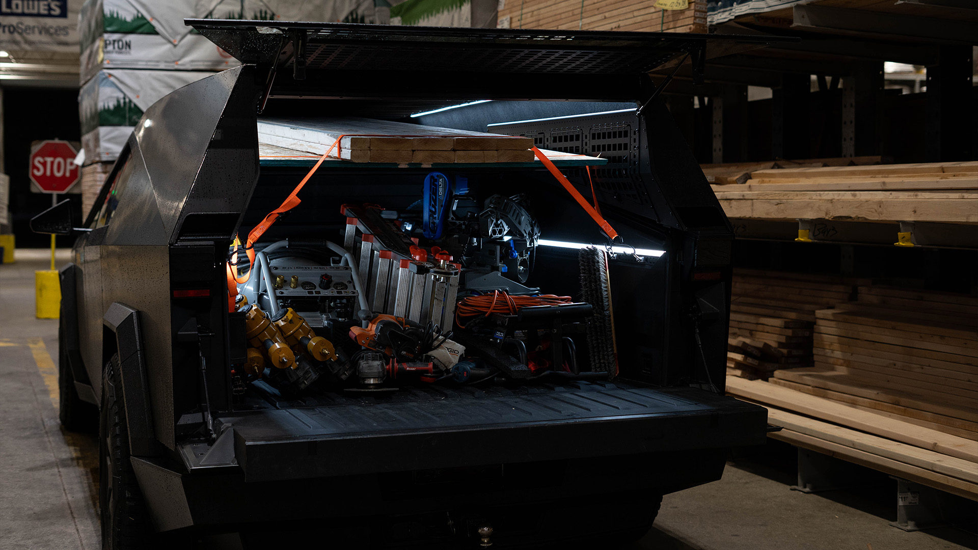 Truck cap packed full of utility gear in a lumber yard