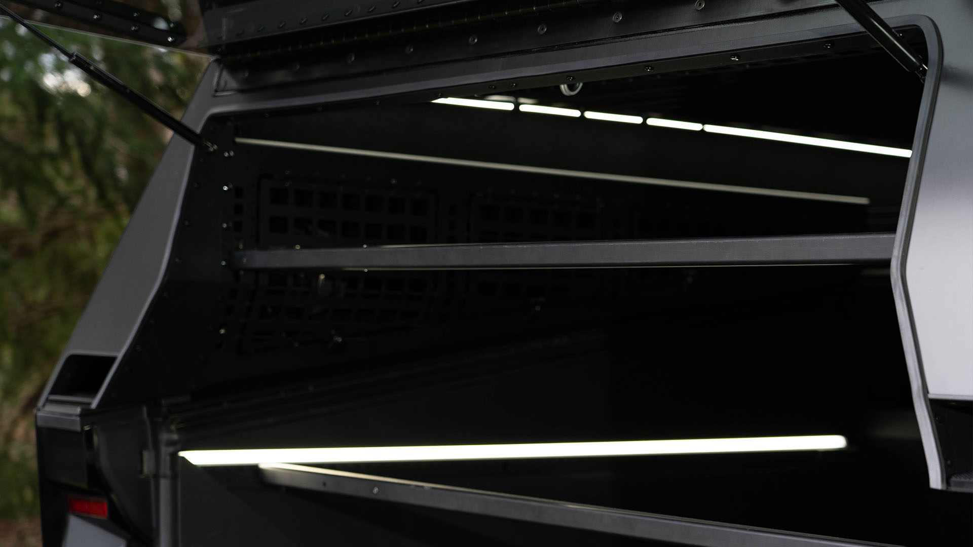 Spanner bars extended to each side of The Cap for securing cargo in the Cybertruck's vault